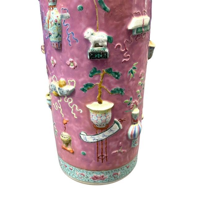 Antique Rose pink porcelain umbrella stand. Sides feature relief decorations, Foo dogs, urns, flowers in bright blues,...