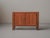 Low sideboard, produced around 1980, crafted from solid elm and elm veneer. Opening through two vertically paneled doors,...