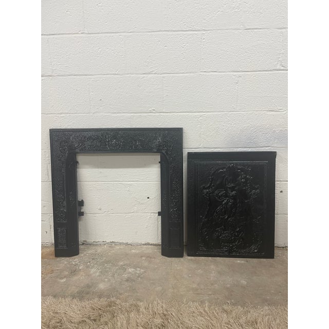 An exceptional piece of 19th-century architectural salvage, this cast iron fireplace surround and matching summer cover...