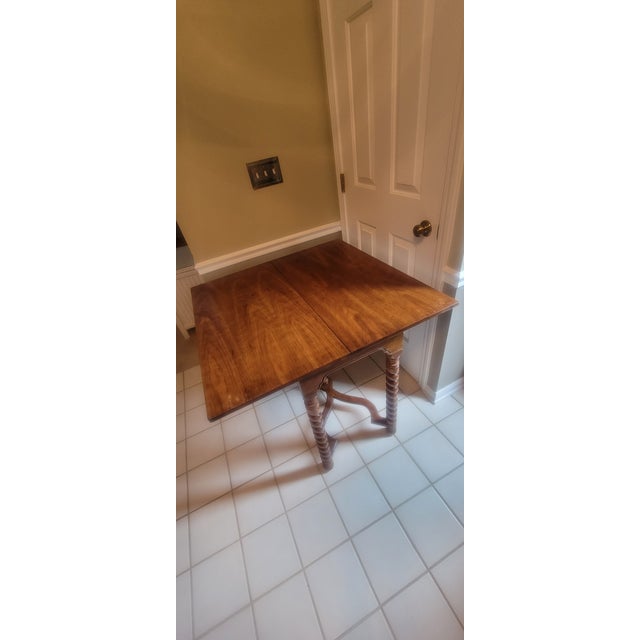 Mid-20th Century Jacobean style flip-top console table with barley twist legs. It incorporates elements of Victorian and...