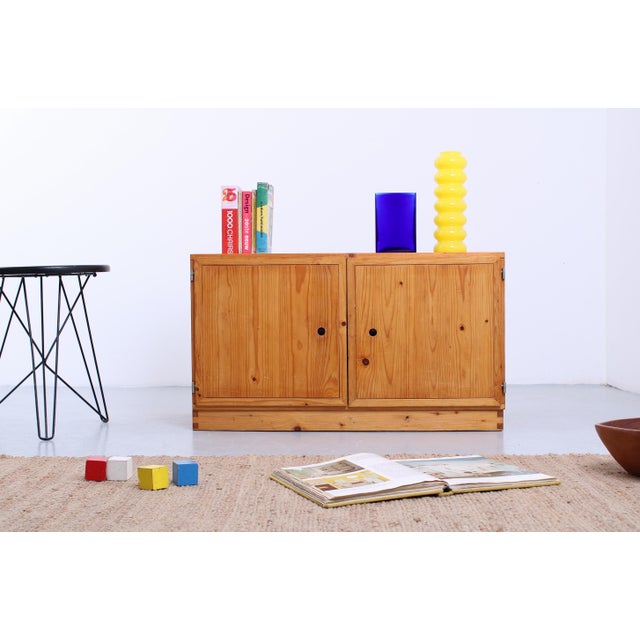 Small sideboard by Ate van Apeldoorn. The natural pine highlights the wood grain, and the finger-jointed panels...