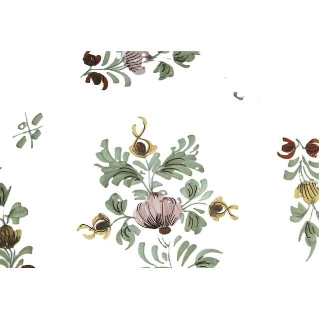 A fine Liverpool delft (or delftware) charger (13 1/4") featuring a floral design to the center and around the...