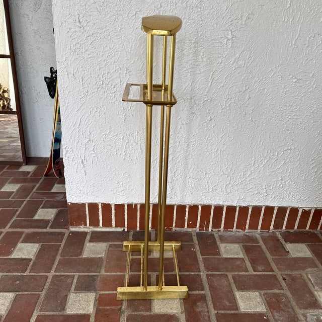 A modernist brass valet stand with a small tray for accessories made in the 1980’s. Possibly by Decorative Crafts