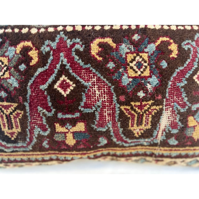 This is a pillow upholstered in a 19th century rug fragment, featuring charming tribal motifs. There is wear on several...