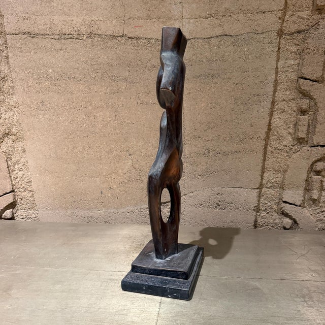 For your consideration, an abstract faux bronze or patinated composite sculpture of a stylized female figure, mounted on a...