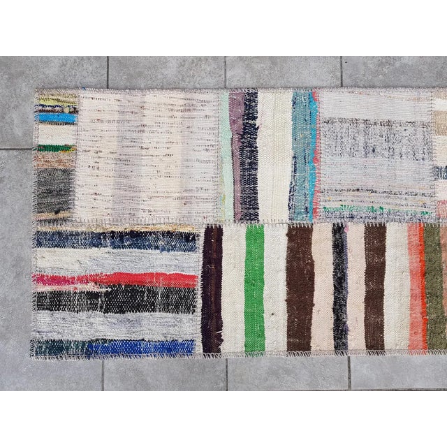 This is a vintage Turkish Oushak rug from the Mid 20th Century. The piece was hand-knotted.