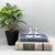Delightful pair of antique porcelain spaniel dog figurines perched atop rich cobalt blue cushions with hand-painted gilt...