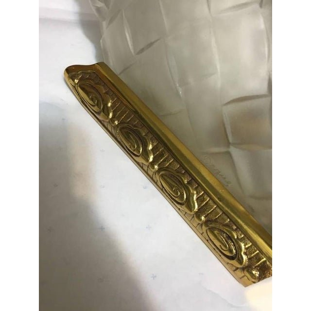 Stunning set of four French Art Deco sconces signed by Degue. With molded clear frosted glass decorated with floral motif....