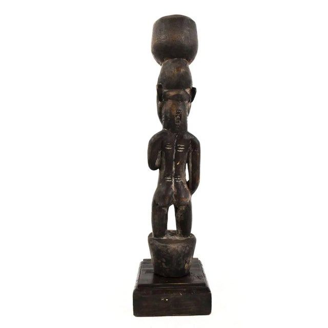 The Senufo Pounder Miniature Figure, standing tall at 13.5 inches, encapsulates the essence of Senufo culture from CÃ´te...