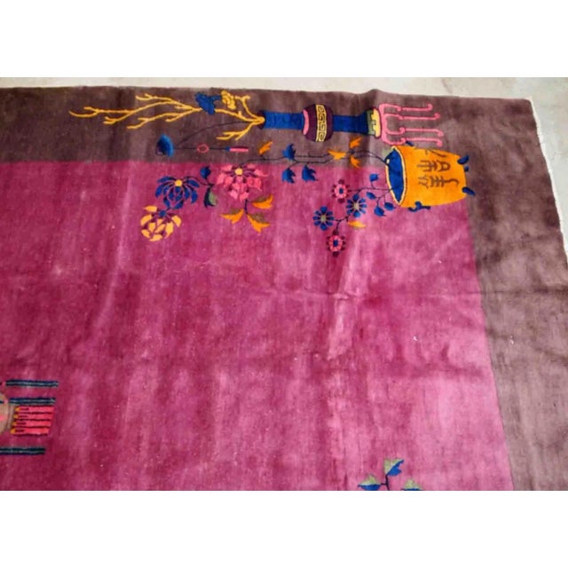 Handmade antique Art Deco Chinese rug in ruby and burgundy shades. The rug is from the beginning of 20th century in...