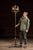 Tall wrought iron floor candelabra with a strong vertical presence, built around a slender central shaft rising from a...