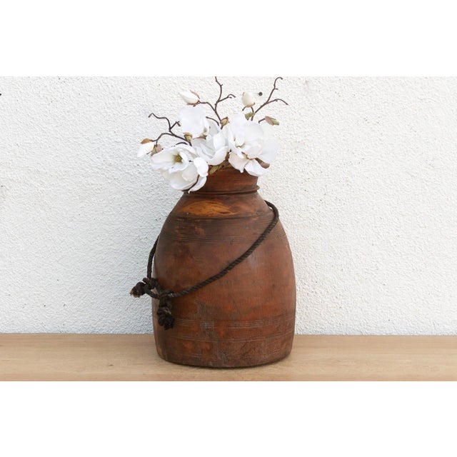 Originally used in village homes for storing milk, ghee, or grains, this antique wooden pot has survived generations of...