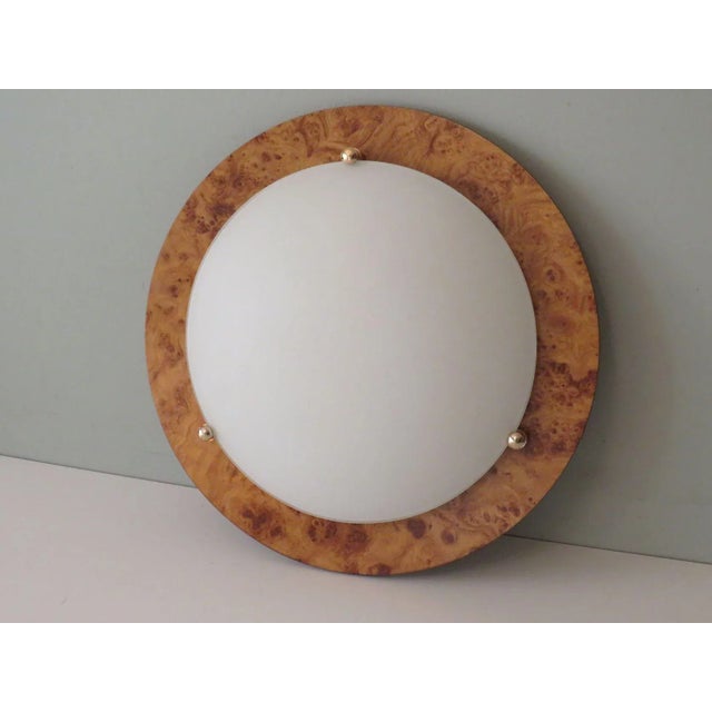 Large round ceiling lamp or wall lamp with faux burlwood plate and white, frosted glass dome, the dome is held on the...