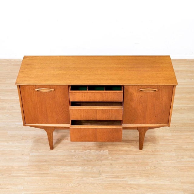 This elegant mid-century teak credenza by Jentique Furniture showcases the refined craftsmanship and clean lines that made...