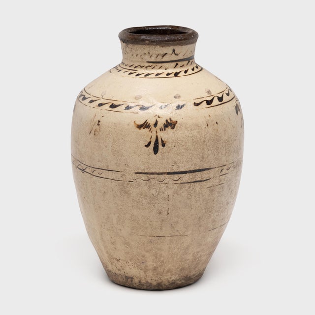 This richly glazed Chinese vase was shaped by hand in the mid-19th century, originally used to store wine and spirits made...