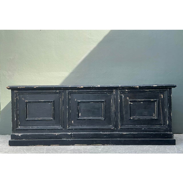 This monumental vintage store counter is an exceptional example of industrial-age retail design, blending architectural...