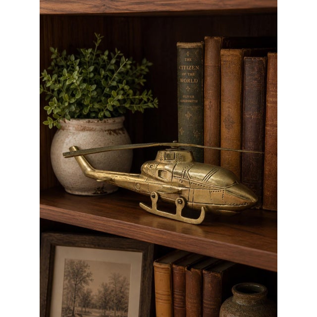 Bring vintage aviation charm to your home with this solid brass helicopter sculpture. Featuring detailed engraved panel...