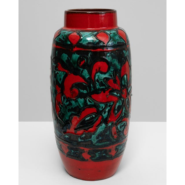 This 20th-century German ceramic vase, stamped W. Germany, is a vibrant example of mid-century decorative art. The...