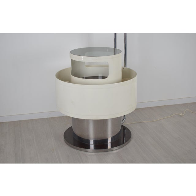 A floor-standing bar cabinet, an icon of 1970s Italian design, featuring a futuristic and functional line. The structure...