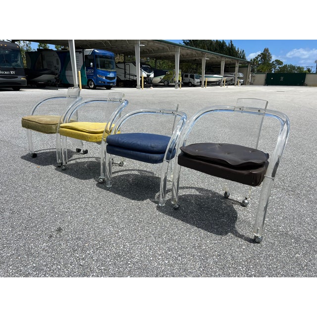 Offered is a set of eight mid century modern Charles Hollis Jones style Lucite arm chairs on casters. This set is in the...