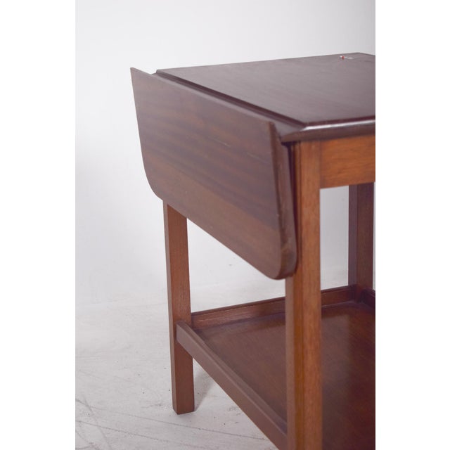 Tea trolley with flaps. The rectangular top has two folding side flaps, which can be lifted to extend the support surface....