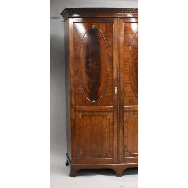 Edwardian flame mahogany bow front triple wardrobe A fine quality Edwardian period flame mahogany bow front triple...