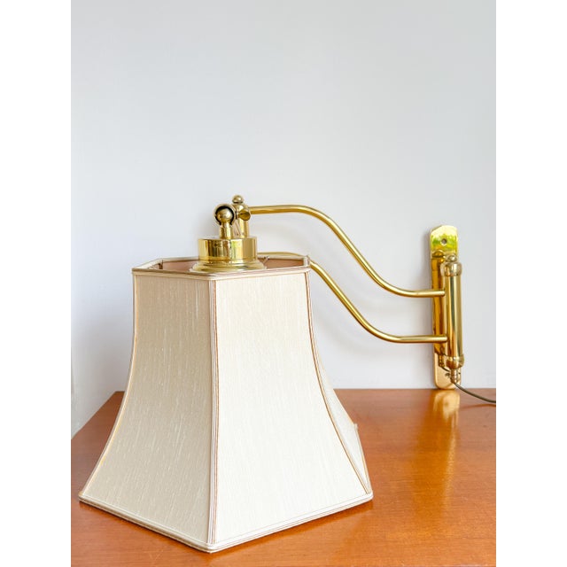 Beautiful mid-century wall lamp with swing arm in excellent condition! the brass frame is rotatable and adjustable using...
