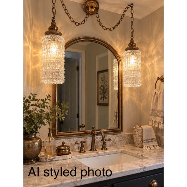 Beautiful vintage Hollywood Regency double swag chandelier featuring two matching cylindrical clear glass shades with...