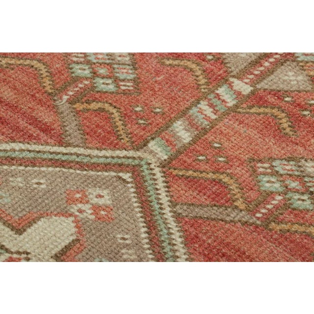 Made with hand-knotted wool, this 2x3 gift-sized vintage Turkish rug originating circa 1950-1960, is a bold new addition...