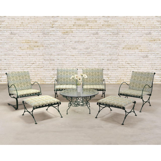 An elegant six-piece mid-century modern garden suite comprised of four lounge armchairs and two ottomans, made in by O.W....