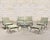 An elegant six-piece mid-century modern garden suite comprised of four lounge armchairs and two ottomans, made in by O.W....