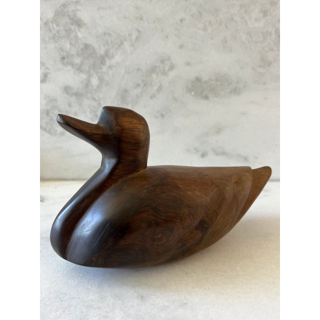 Vintage hand carved wood duck figure. Heavy weight and perfect for paperweight or shelf decor.