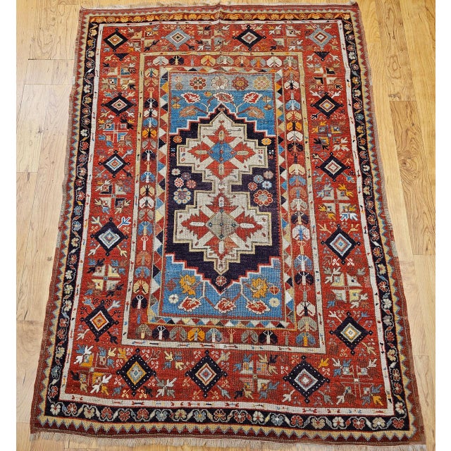 A beautiful handwoven Anatolian village rug in the traditional prayer design format, woven with natural vegetable dyes in...