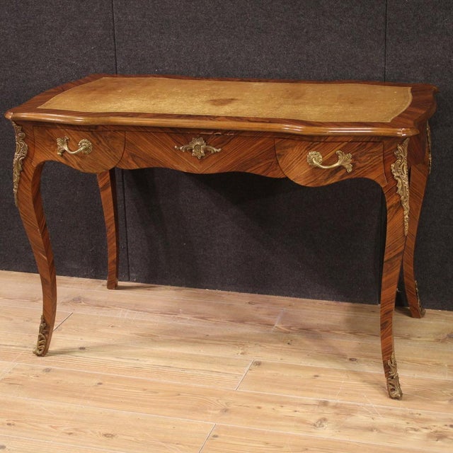 French writing desk from the second half of the 20th century. Louis XV style furniture veneered and carved in walnut and...