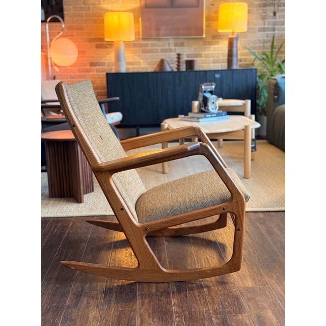 This Danish Rocking Chair by Søren Georg Jensen is constructed with a teak frame and sculpted arms.