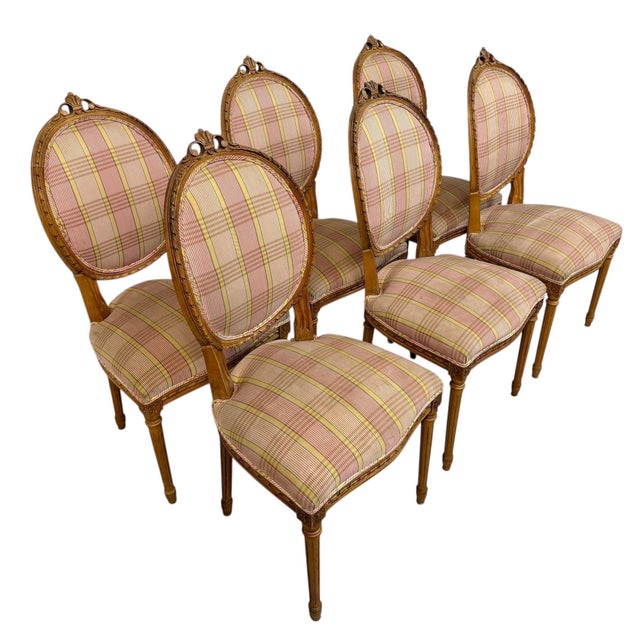 Elevate your dining space with this elegant set of six vintage Louis XVI style dining chairs, showcasing timeless French...