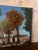 Beautiful original landscape painting depicting a charming village or country setting with mature trees, autumn foliage,...