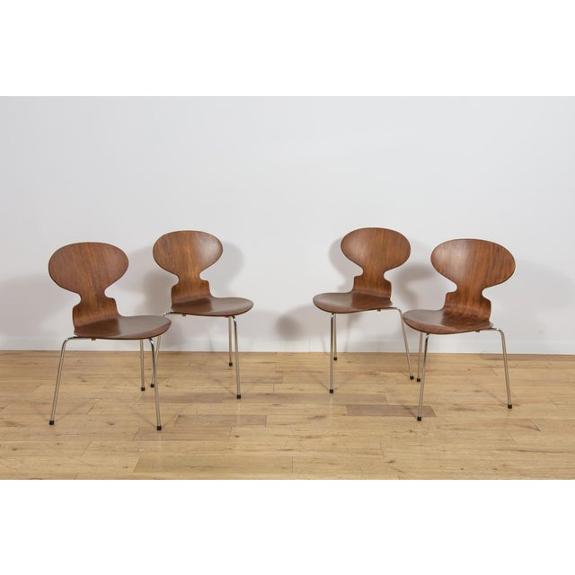 This set of four iconic Model 3101 “Ant” chairs was designed by Arne Jacobsen for the renowned Danish furniture...