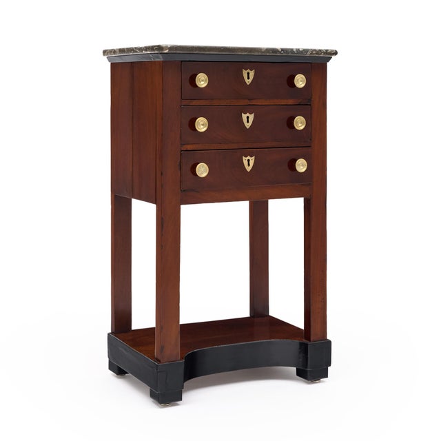 An elegant French Consulat to early Empire side table, circa 1800–1810, crafted in richly figured mahogany and retaining...