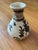 A rustic Chinese Cizhou kiln ceramic vase featuring classic hand-painted iron-black slip decoration over a creamy glaze....