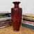 "About This Piece About This Piece This striking crimson vase embodies timeless artistry with a modern edge, its rich...