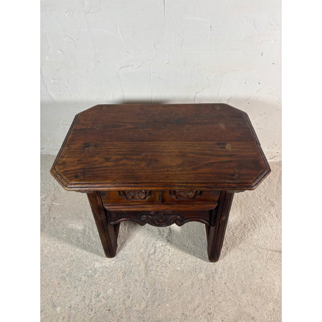 Charming small Spanish side table crafted in solid wood, featuring a carved drawer front with floral motifs and original...