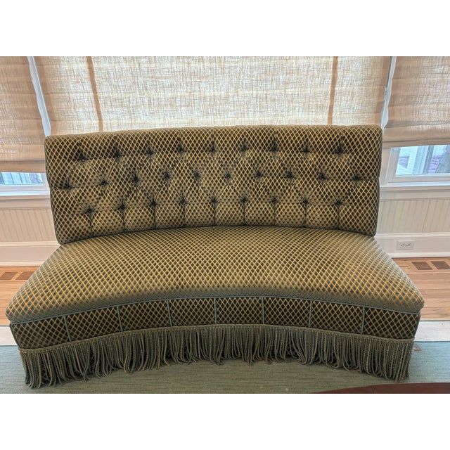 Custom Kravat fabric banquette slash loveseat with a curved back and tufted back tight seat with a fringed skirt. This...