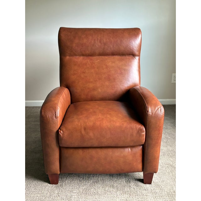 Handsome contemporary recliner lounge chair by Comfort Design upholstered in rich cognac brown leather. Featuring a clean-...