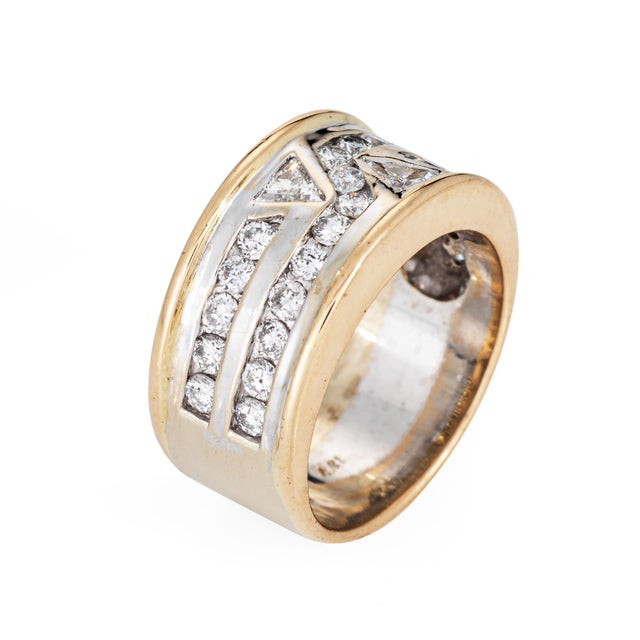 Stylish vintage diamond cigar ring (circa 1980s) crafted in 14 karat yellow & white gold. Mixed cut diamonds (trillion and...