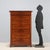 Charles X mahogany weekly chest. Black marble top, seven drawers, the first in the molded band beneath the top, and the...