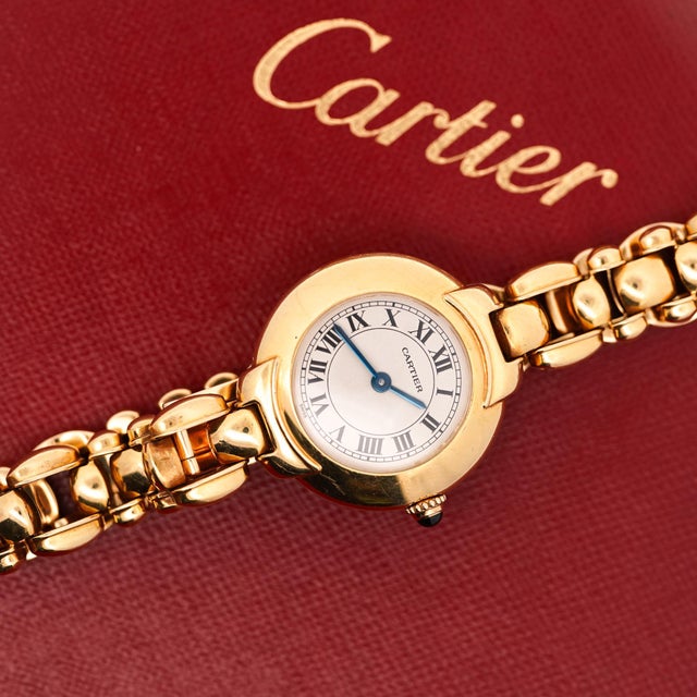 Cartier Vendôme ladies watch 18K yellow gold with a sapphire cabochon crown and a crisp white dial featuring black Roman...