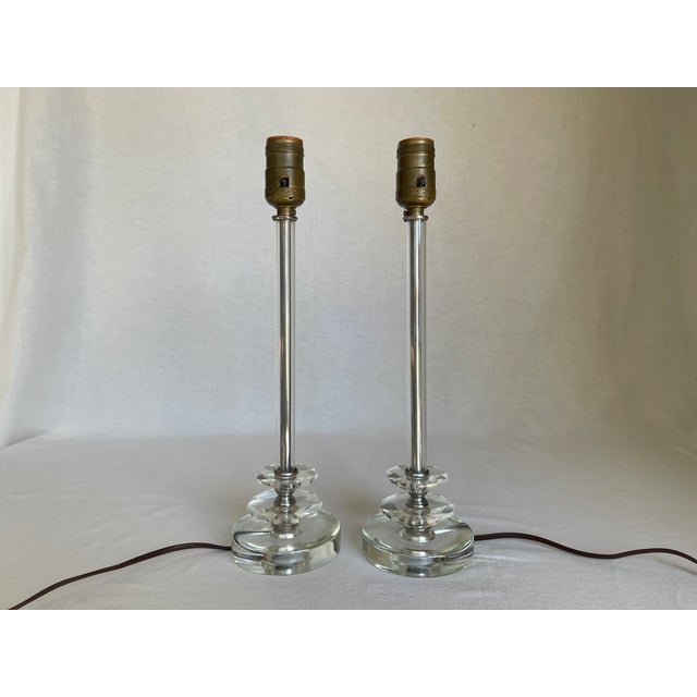 Pair of 1930's Art Deco cut glass lamps with chrome metal accents. Lamps have faceted ribbed glass stems, two cut glass...