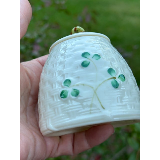 This Belleek marmalade jar with lid is a fine example of Ireland’s world-renowned porcelain artistry. It features...
