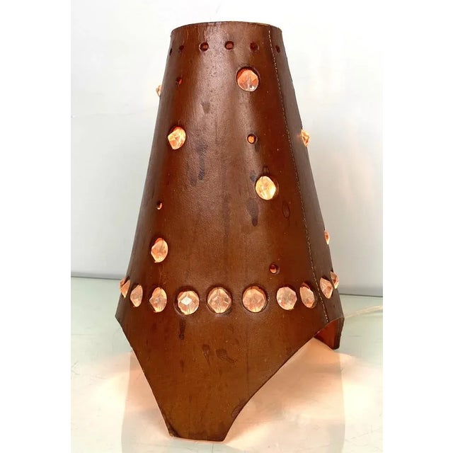 A very rare French Conical shaped thick brown leather table lamp 1960’s, detailed with glass stones. It is clearly visible...